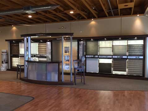Store interior showcasing several different types of window coverings